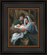 Mary and Joseph hold baby Jesus in the stable.