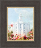 St. George Temple with pick flowers and a blue sky.