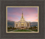 The Saratoga Springs Utah temple from the front with mountains and a sunset.