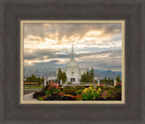 The Orem Utah Temple with light shining through the clouds.