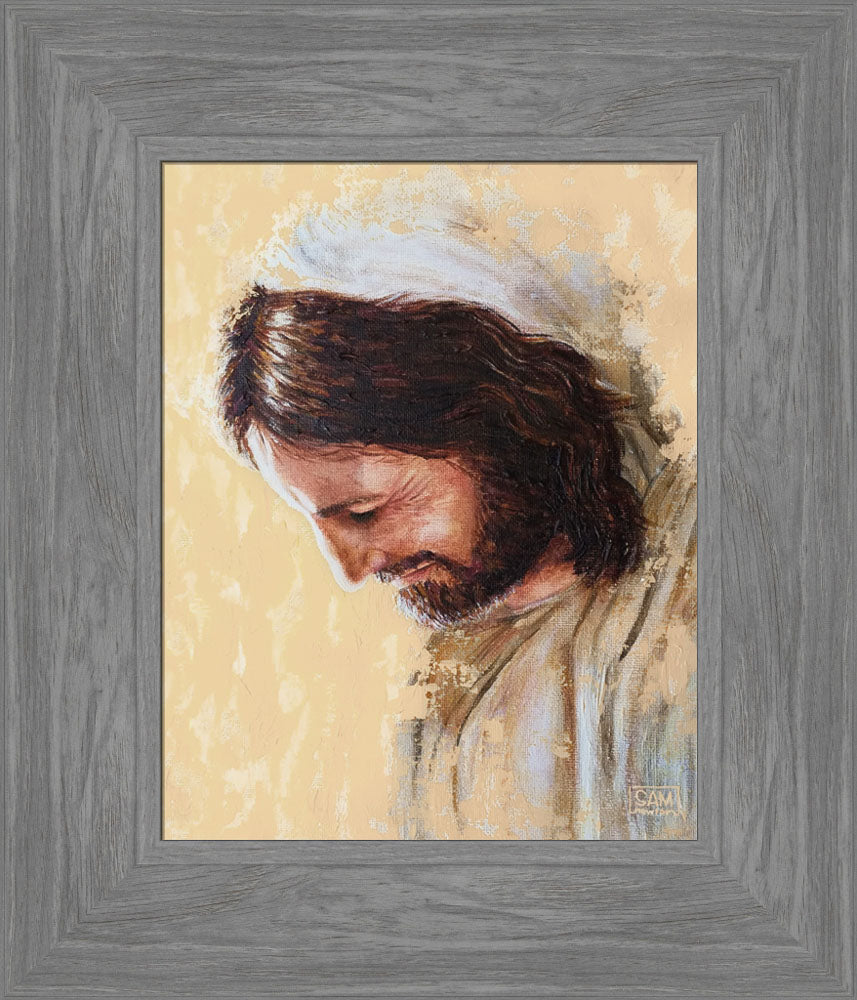 Portrait of Jesus looking downward. He is smiling and surrounded by light. 