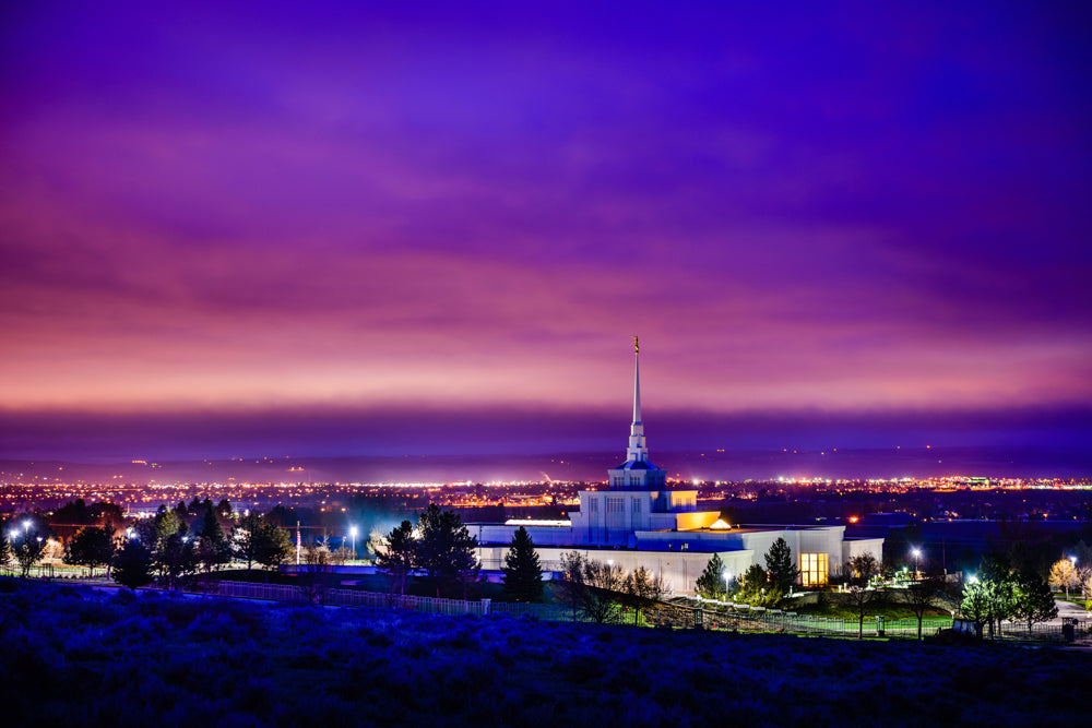 The Billings Montana Temple at twilight with a purple sky.