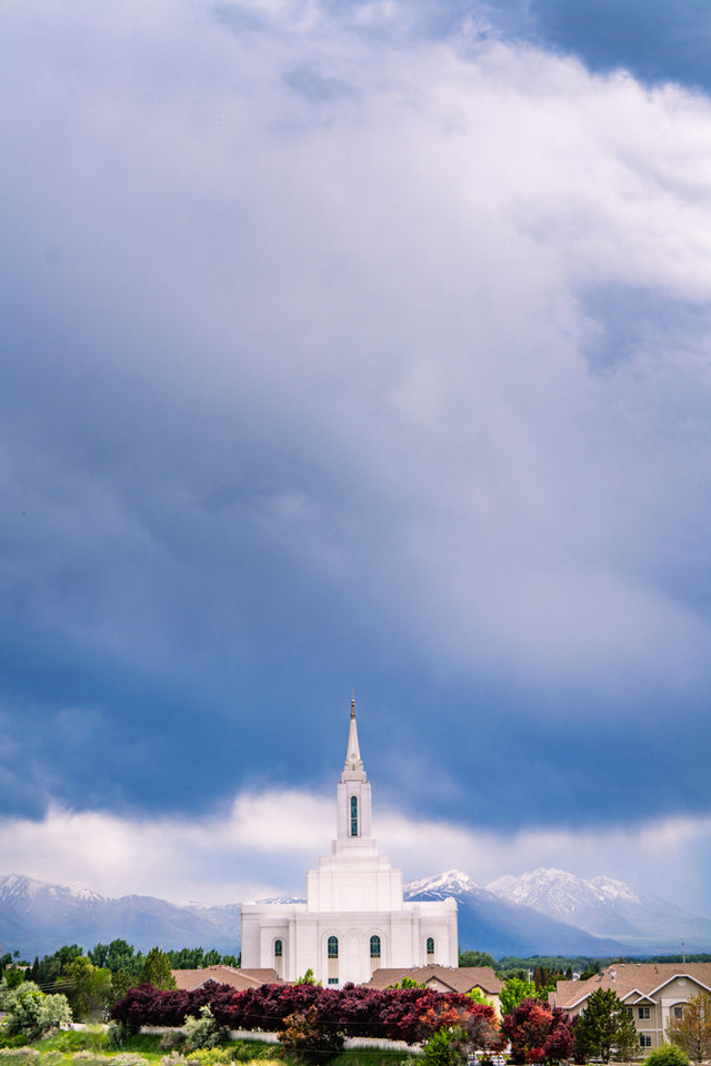 The Orem Utah Temple with a cloudy blue sky.