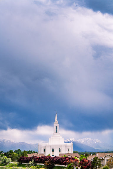 The Orem Utah Temple with a cloudy blue sky.