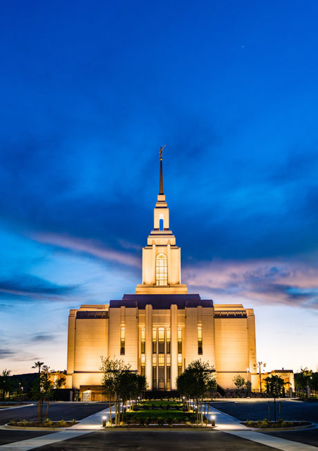 The Red Cliffs Utah Temple lit up in the evening.