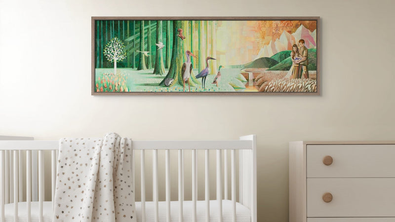 Framed artwork in a nursery with a crib and dresser.