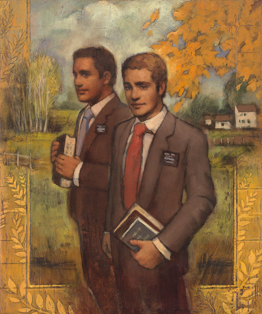 Two elder missionaries holding their scriptures near a field. 