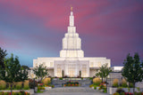 Idaho Falls Temple shining bright against a deep purple sky.