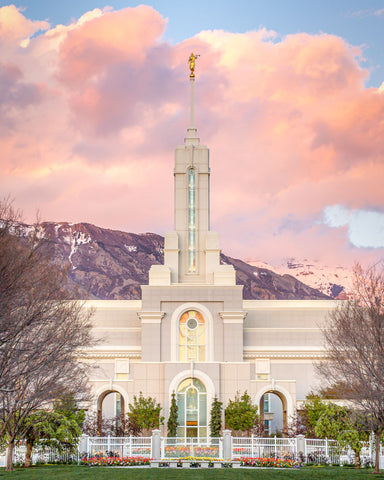 Mount Timpanogos Temple from the front with colorful clouds over the mountain. 
