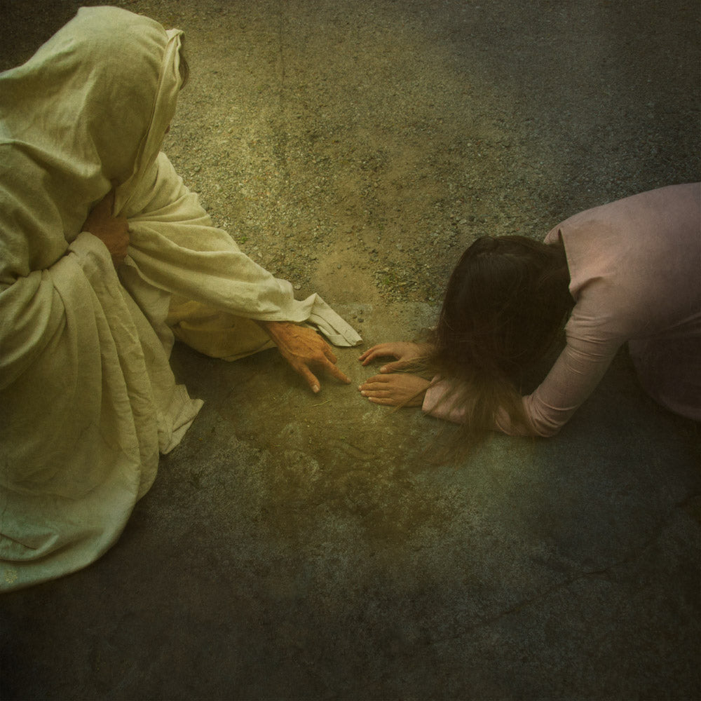 Jesus writing on the ground with a woman who has sinned. 