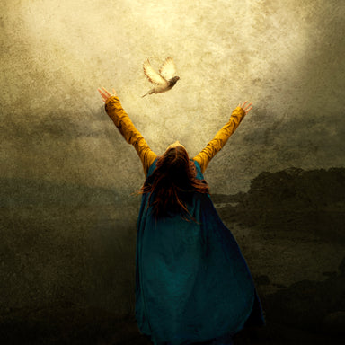 A young woman lifts her hands toward Heaven and looks up toward a dove.