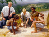 Two missionaries on the ground with group on boys playing a game.