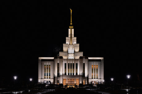 The Saratoga Springs Utah temple lit up at night.