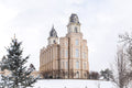 Manti Temple standing against a white sky in the snow.