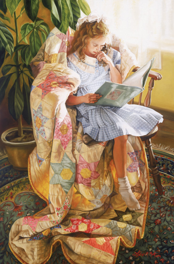 A girl sitting on a quilt in a chair by a window reading. 