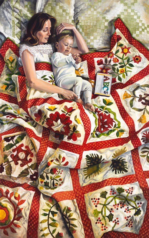 A mother and young child lay with a quilt and a book. 