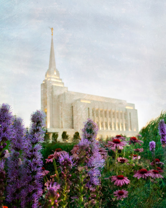 Rexburg Idaho Temple with purple flowers and blue sky. 