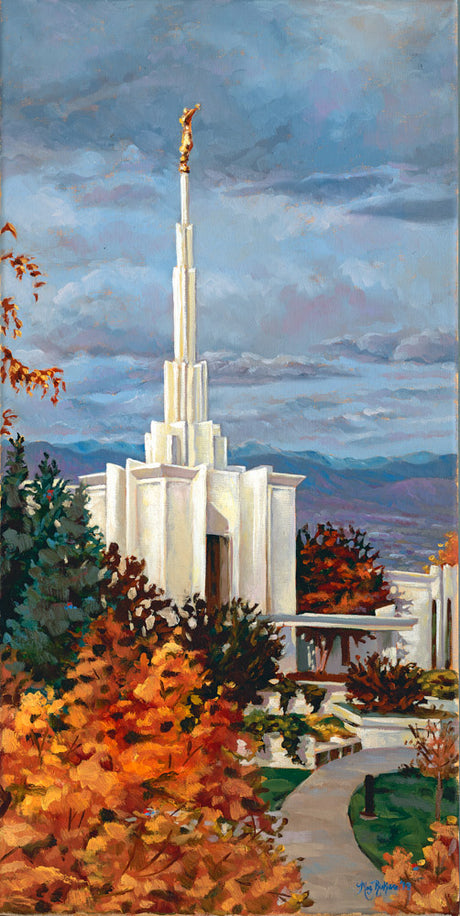 Denver Temple steeple rising above autumn trees.