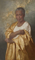 An older black woman in a white dress wearing a gold robe.