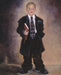 Young boy dressed in a baggy suit as a missionary holding a book of Mormon. 