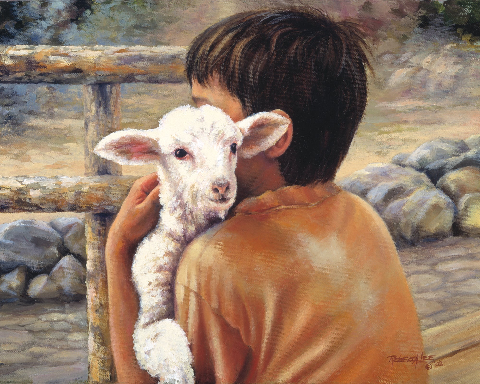 Young boy holding a white lamb. 