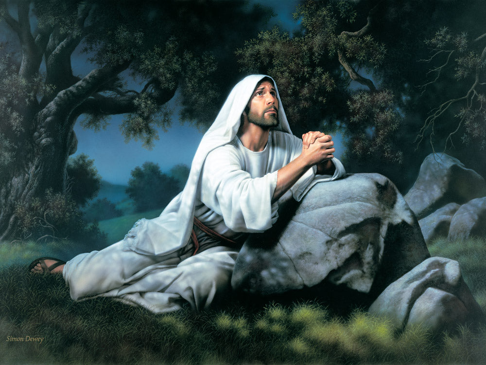 Christ kneeling at night in the garden of Gethsemane and praying.