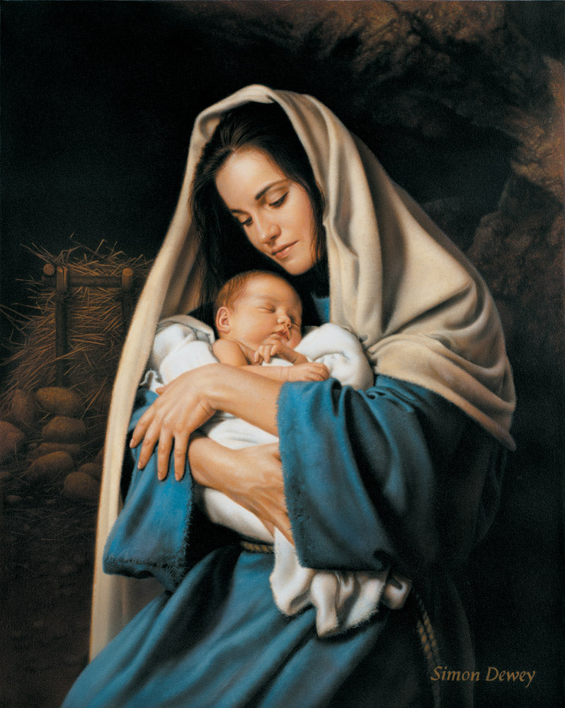 Mary holding baby Jesus in her arms with the manger in the background.