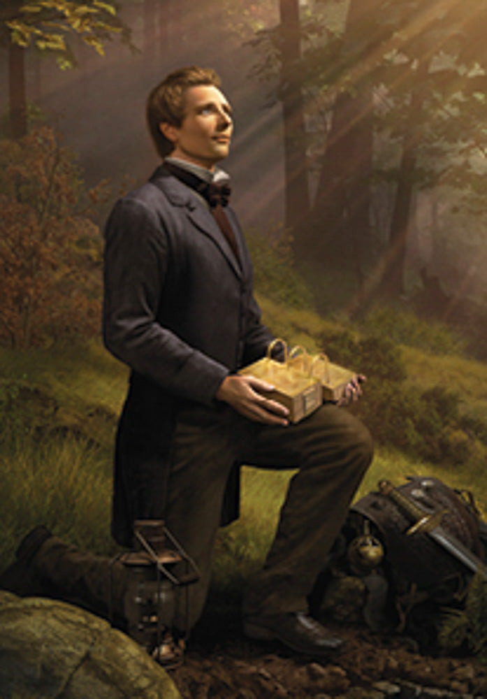 Man kneeling in a forest holding a glowing box with beams of sunlight filtering through trees.