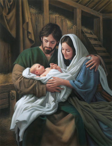 Mary and Joseph hold baby Jesus in the stable.