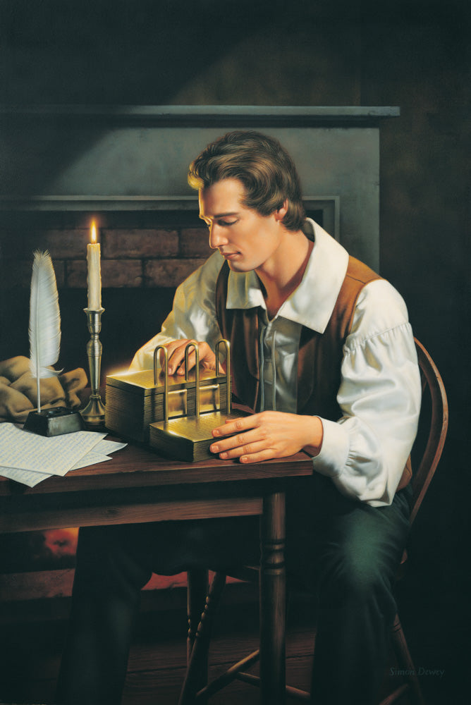 Joseph Smith is seated at a table examining the gold plates.